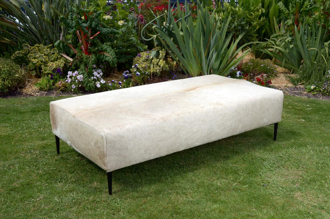 Large cowhide ottoman with black legs